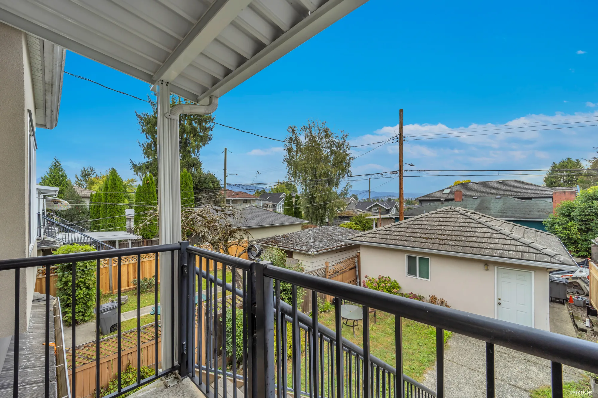 The covered balcony off the upper floor looking over the yard