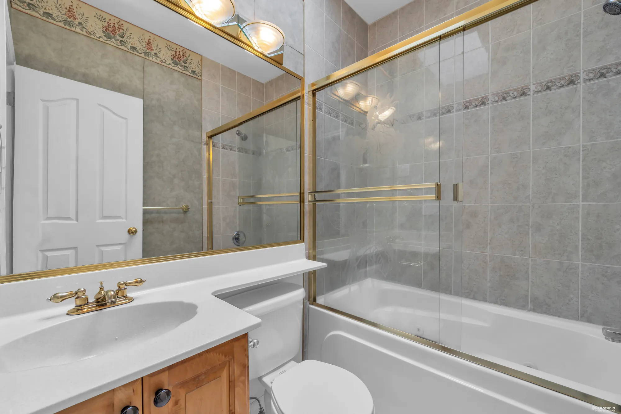 The upstairs bathroom with a corner tub and a glass shower