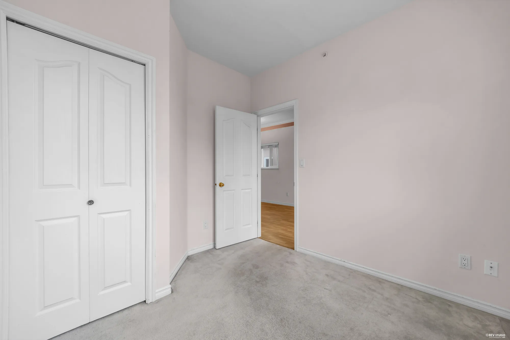 An upstairs bedroom with carpet and a closet, empty