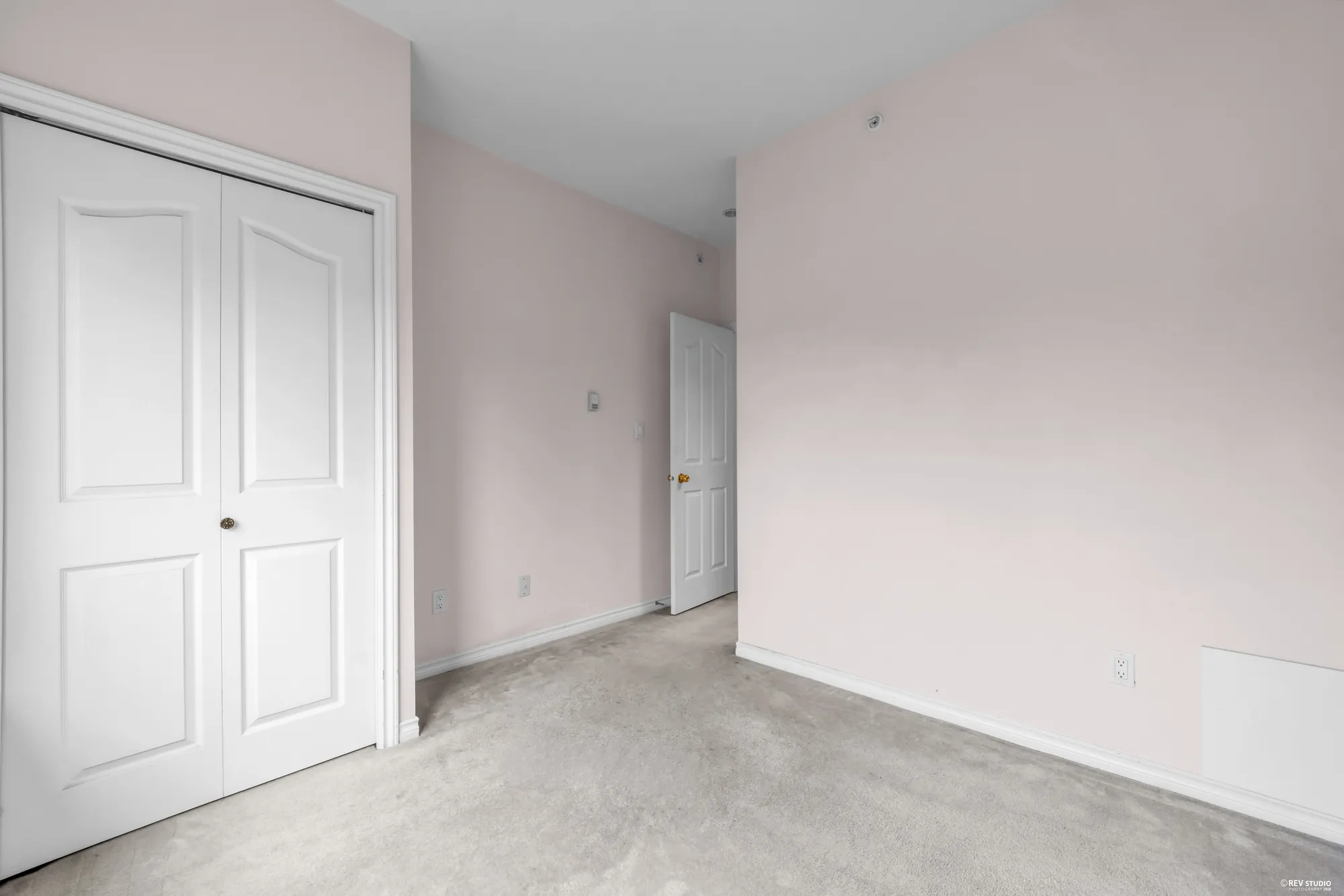 An upstairs bedroom with double closet doors