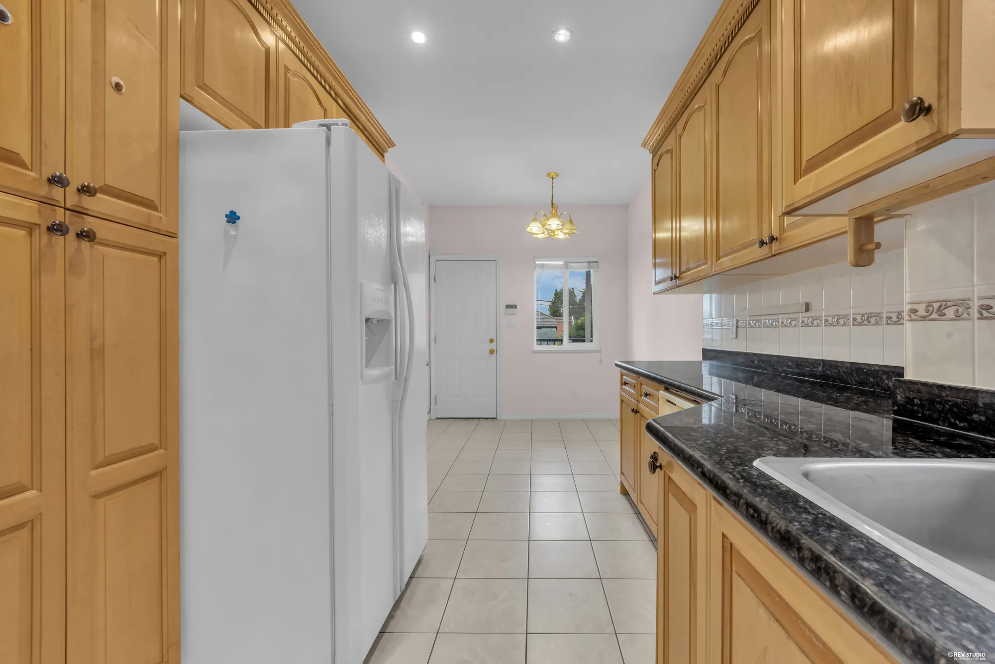 The kitchen with the pantry cabinets and the doorway to the hall