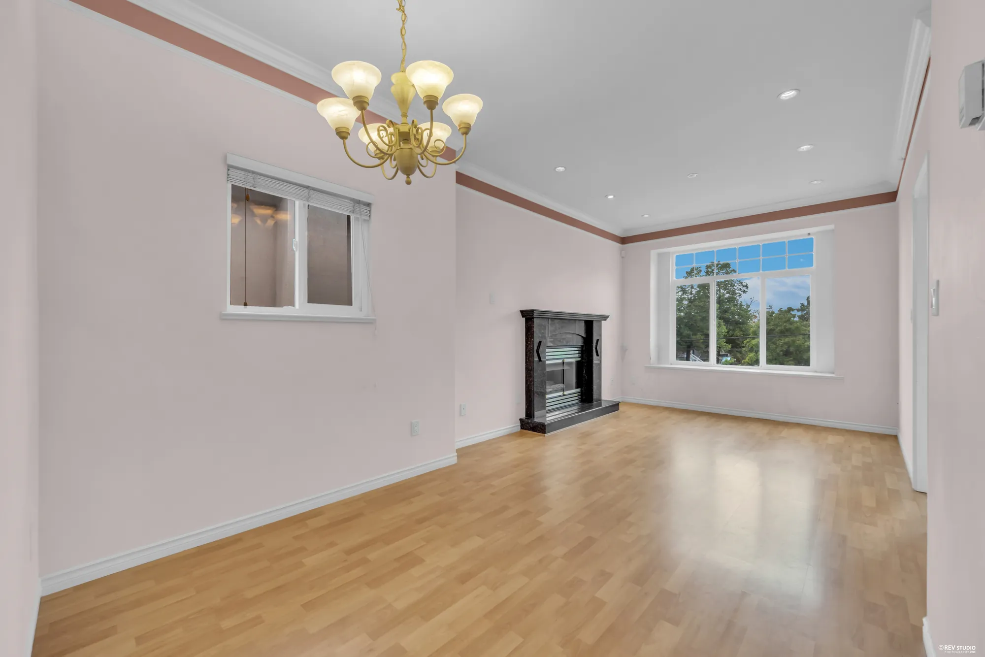 The upper living room from the far corner, with the fireplace on the right