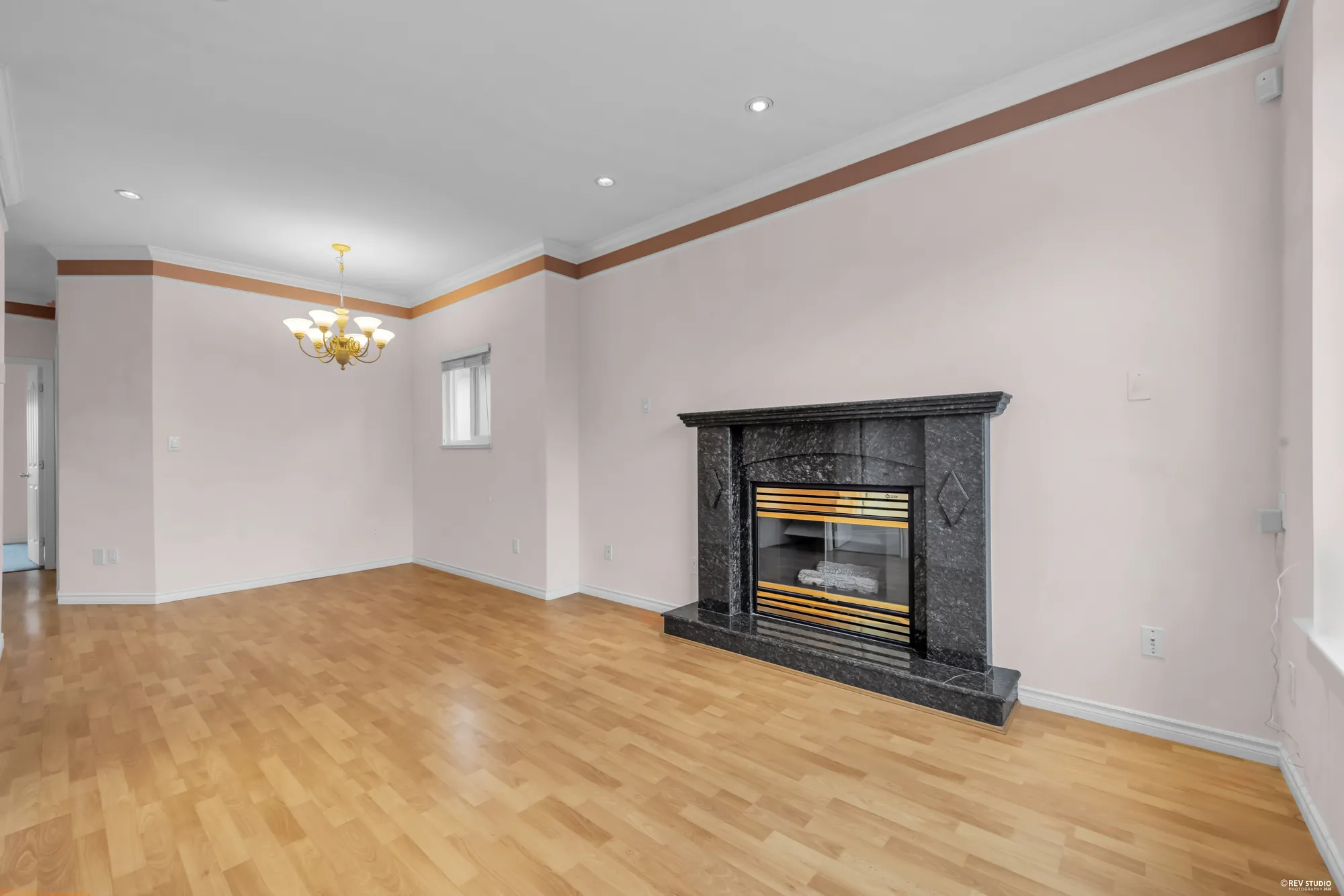 The dining area with a chandelier and the fireplace beyond