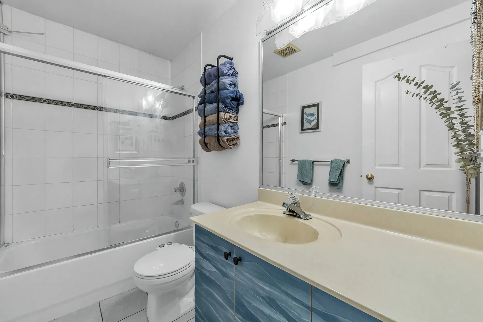 The second main-floor bathroom with a long vanity, photographed after clutter was digitally removed
