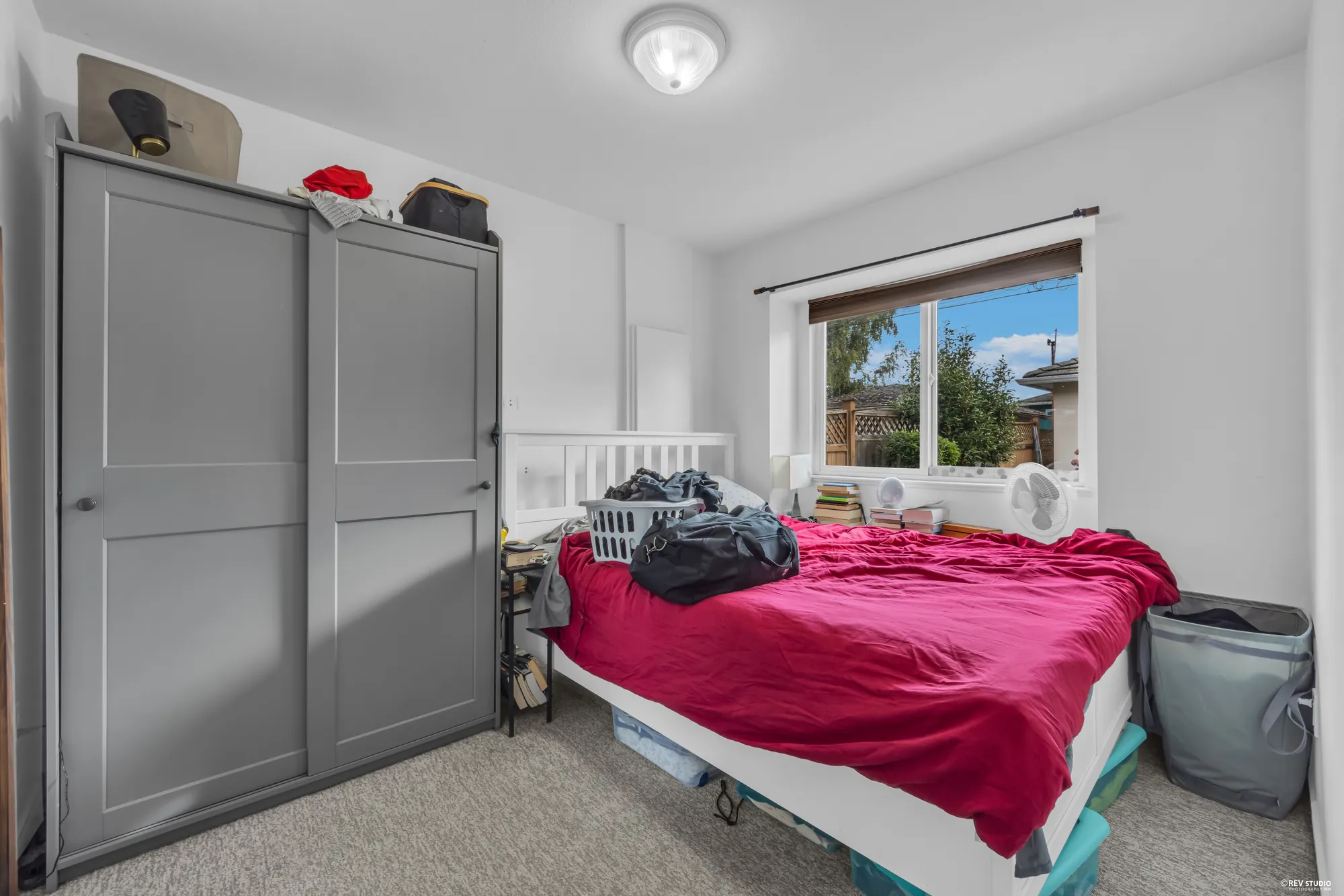 A main-floor bedroom, occupied, with a wardrobe and a window