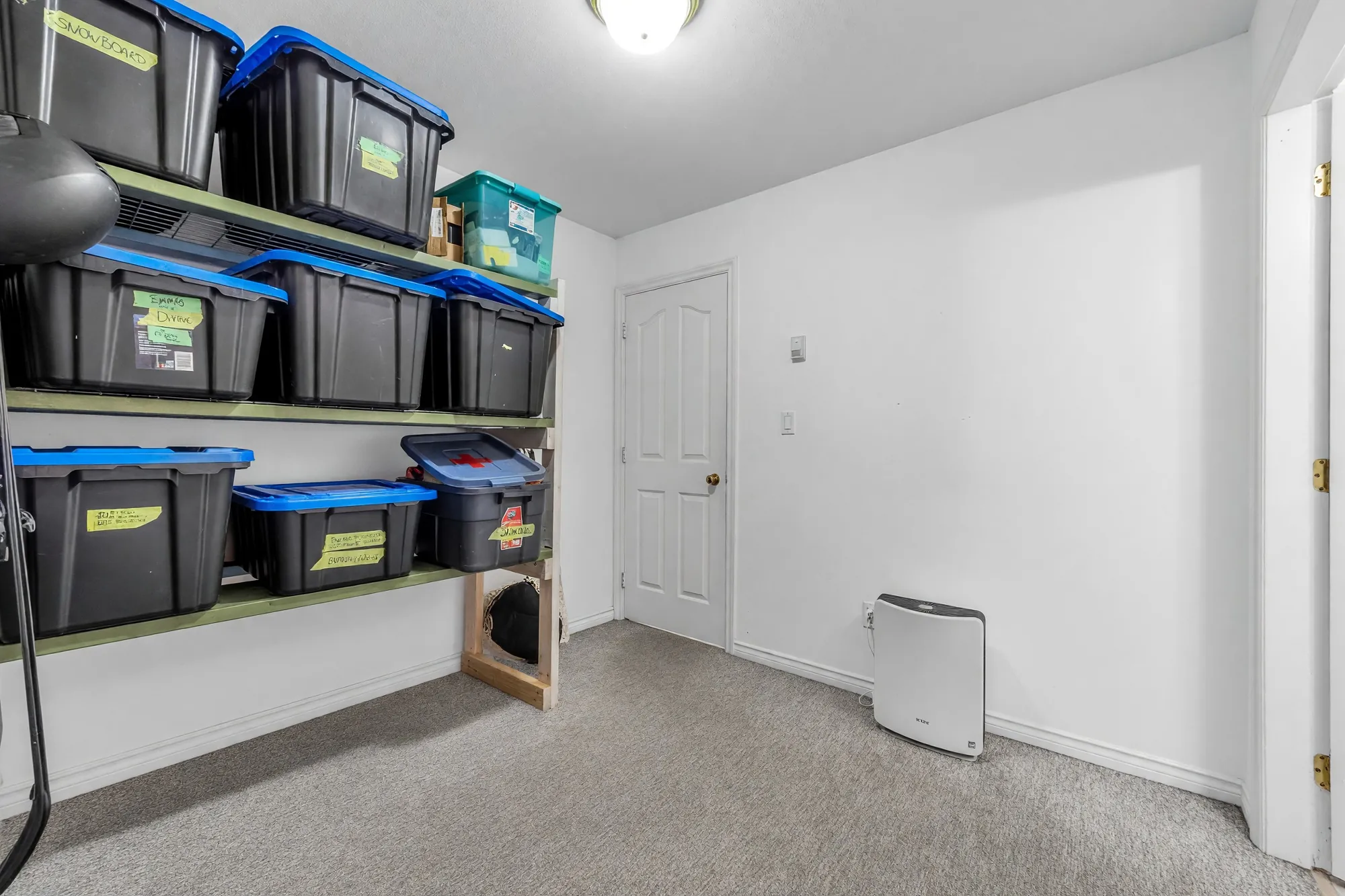A main-floor storage room with shelving, photographed after clutter was digitally removed