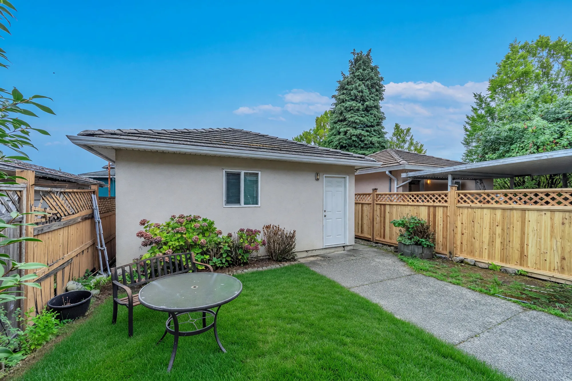 The back yard with the detached garage at the far end